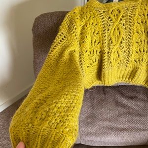 A yellow cropped sweater from Urban Outfitters